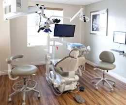 Exam room with dental chair, monitor, and equipment
